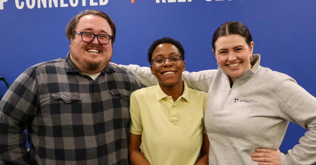 Three AtNetPlus teammates, PJ, Faith, and Becca,