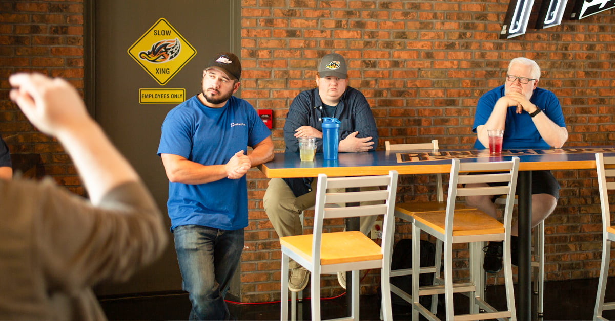 Three CJIS certified technicians participating in a company outing in Akron, Ohio, showcasing our story commitment to secure and compliant technology solutions, continuous learning, and team building.